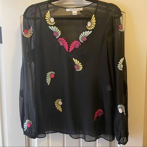 Diane von Furstenberg black sheer top with stitched floral design.
